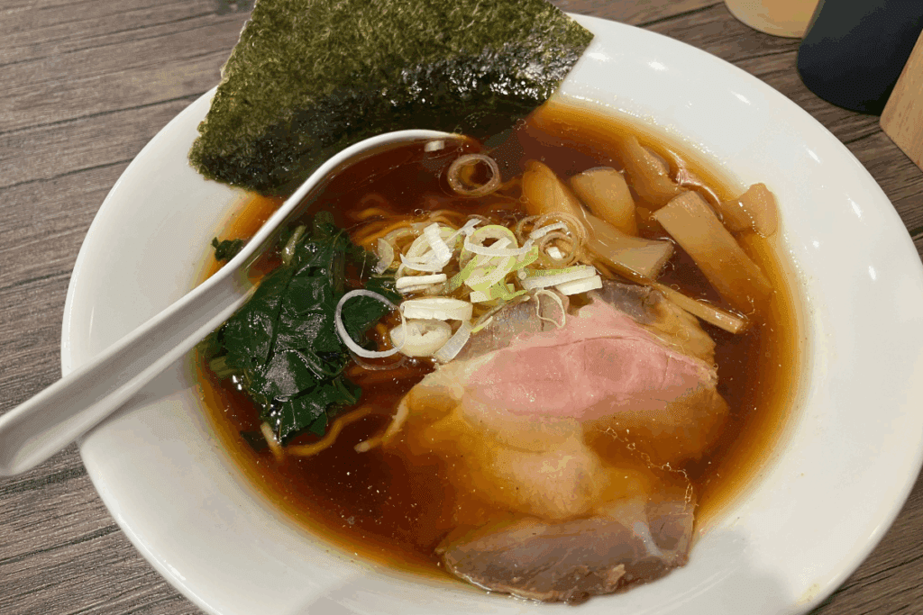 Shoyu ramen with pork, seaweed, spinach, and bamboo shoots at Oreno Oshimen, a ramen shop in Fukuoka inspired by Japan’s underground idol culture.